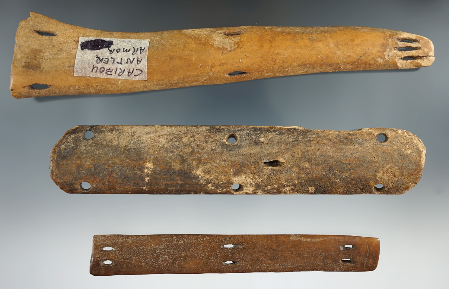 Three sections of Inuit bone armor found in Alaska, largest is 7 3/8".