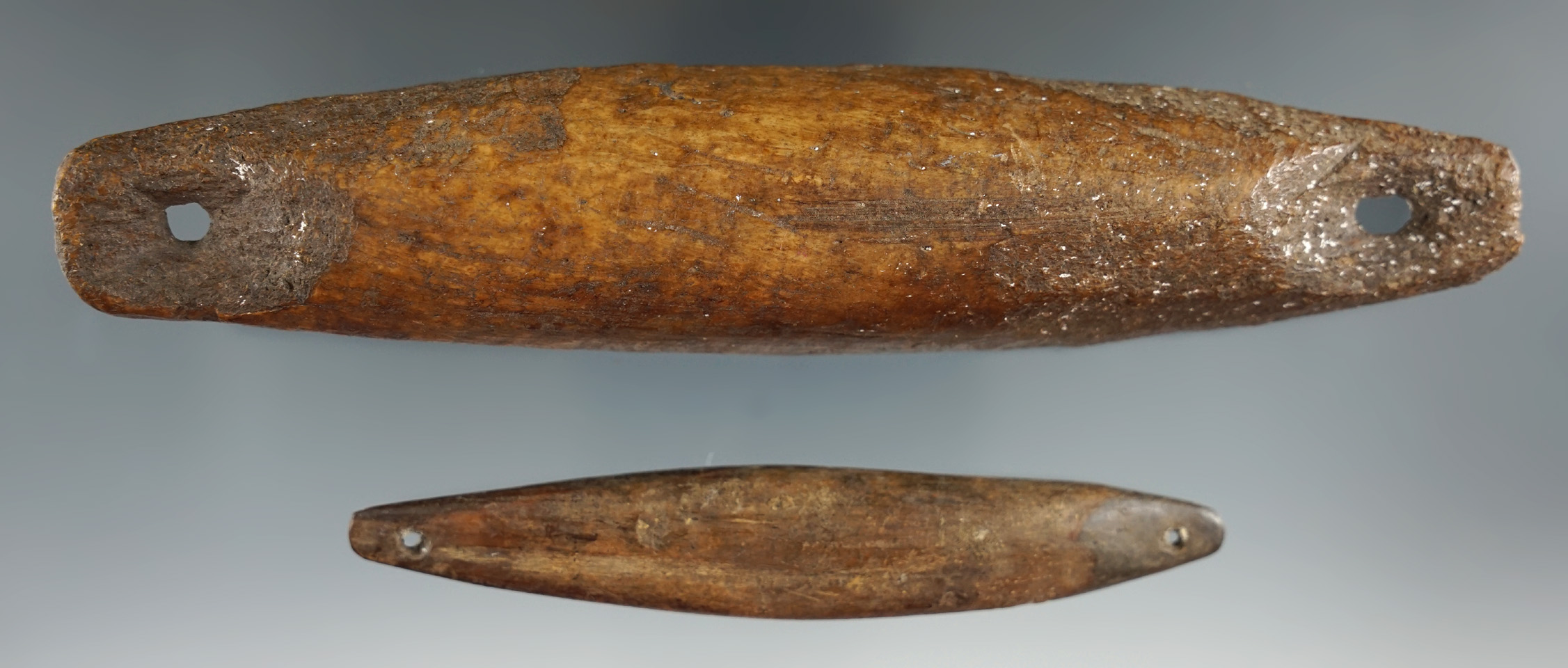 Pair of Inuit line separators made from bone found in Alaska, largest is 6 1/4".