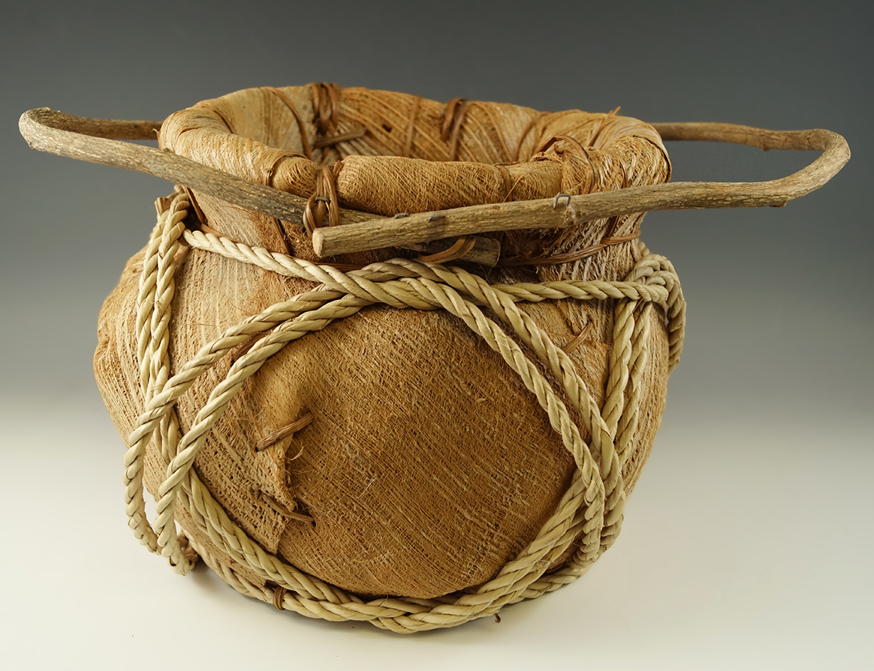 10" wide by 8" tall well made contemporary palm leaf basket from the Pacific Islands.