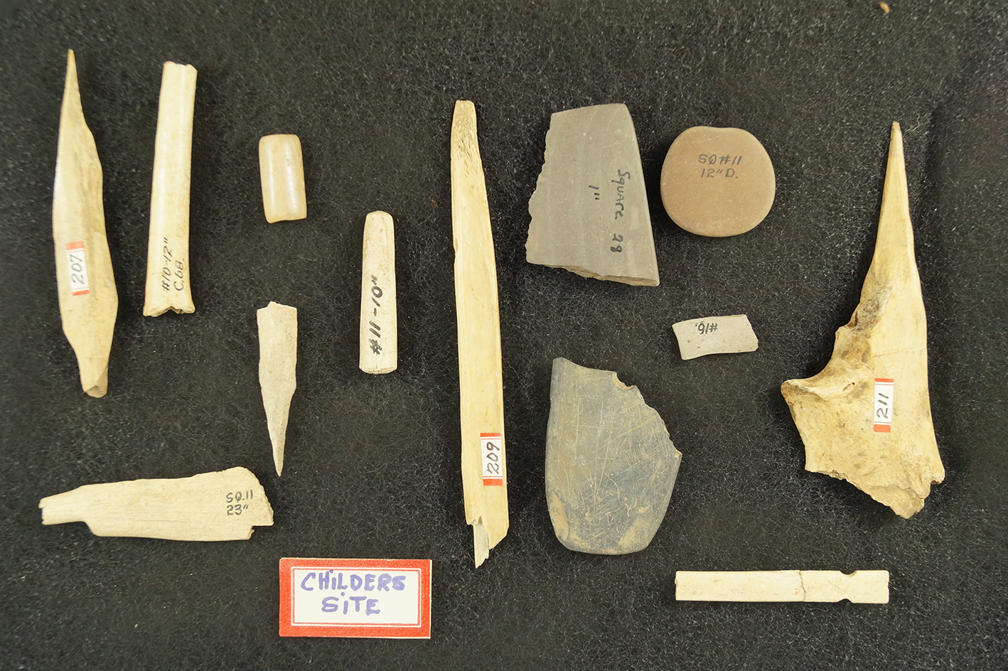 Frame set of stone, slate and bone artifacts all found at the Childers site, largest is 4 15/16".