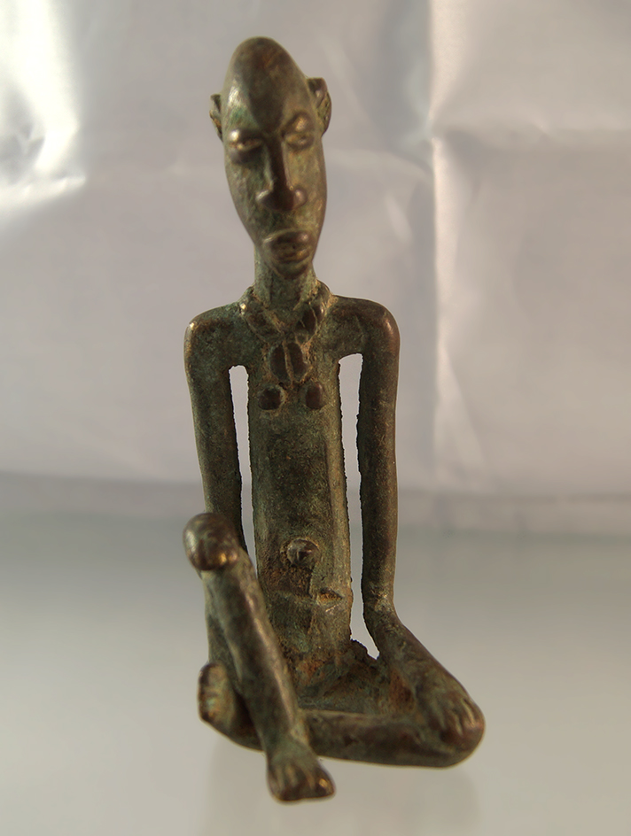 Unique 4 7/8" copper or bronze statue that is heavily patinated from Africa.
