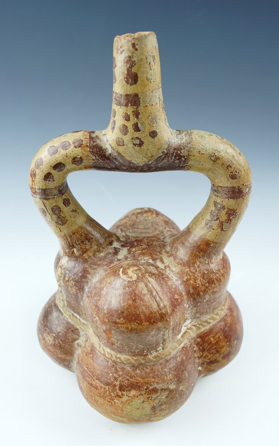 8 1/2" Tall x 4 3/4" Wide Moche V Stirrup Bottle depicting 4 rope tied bundles. Found in Peru.