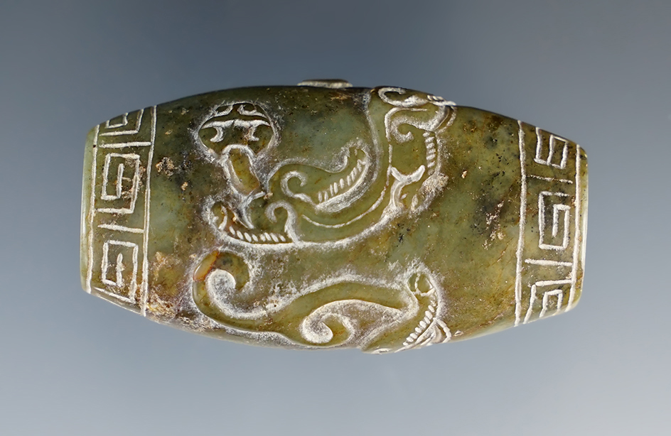 Exceptional artwork on this 2 1/6" Jade Bead/Pendant depicting two dragons, found in Burma.