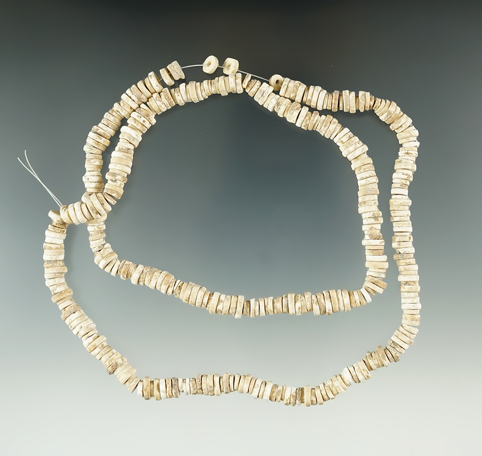 20" Long strand of nicely patinated drilled shell beads.