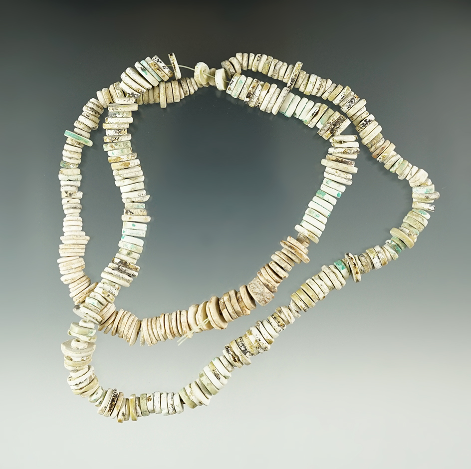 20" Long strand of heavily patinated drilled shell beads. Ex. Gilbert Dilley Collection.
