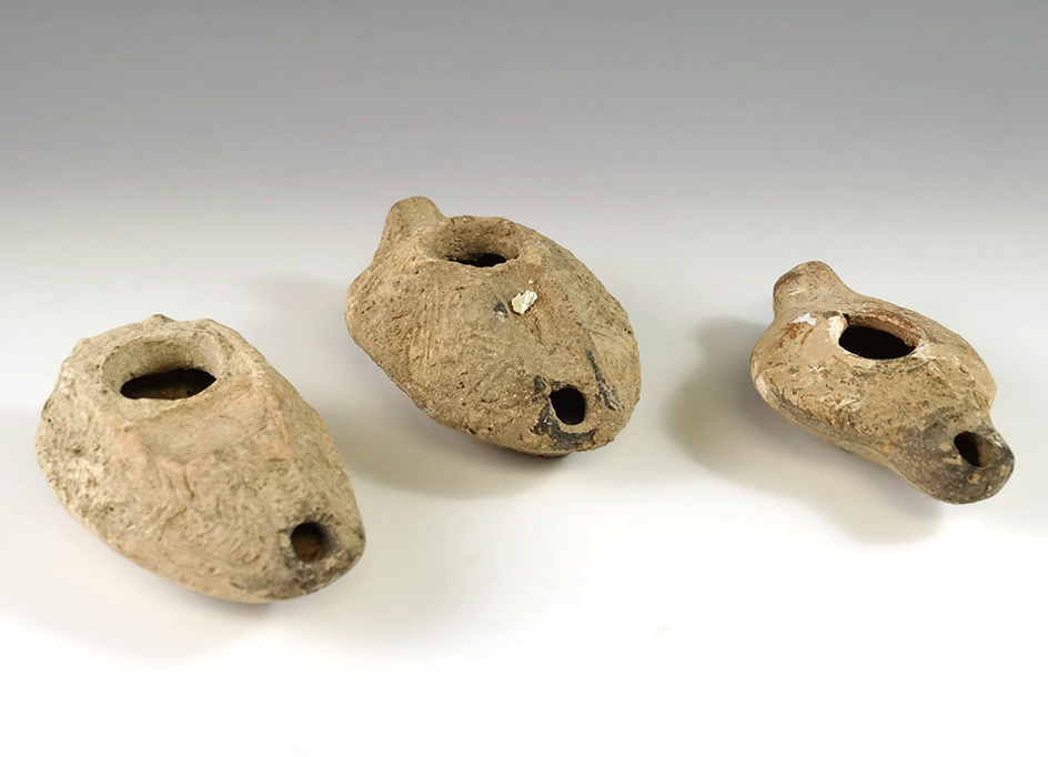 Set of three Samaritan terra-cotta oil lamps found in Jerusalem dating between A. D. 100-700.