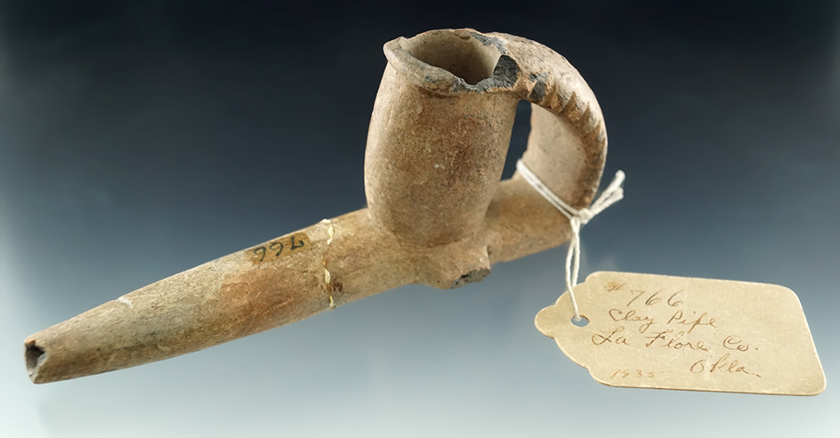 5" nicely styled clay pipe with excellent age on surface. Broken and glued at the stem midsection.