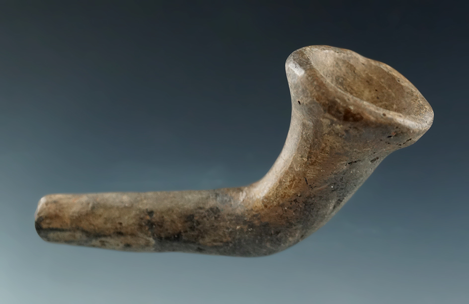 2 7/8" miniature Iroquois clay trumpet pipe which is mended at the elbow found in New York.