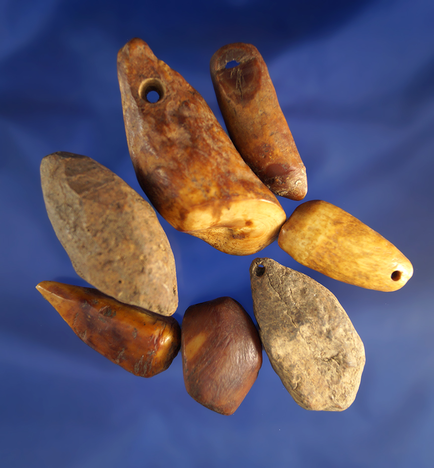 Set of seven drilled plummets made from bone found in Alaska, largest is 2 3/8".