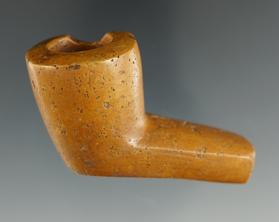 2 5/8" x 1 1/2" Pipe made from Pipestone with a human image carved in the stem. Ancient rim chip. Fo