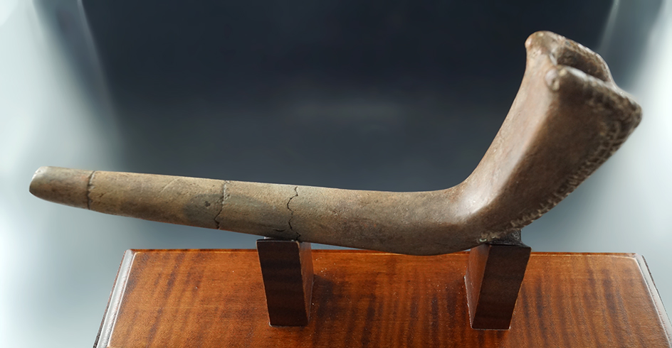Uniquely styled 7" long Iroquois Clay Pipe with restoration to the bowl - broken and glued stem.