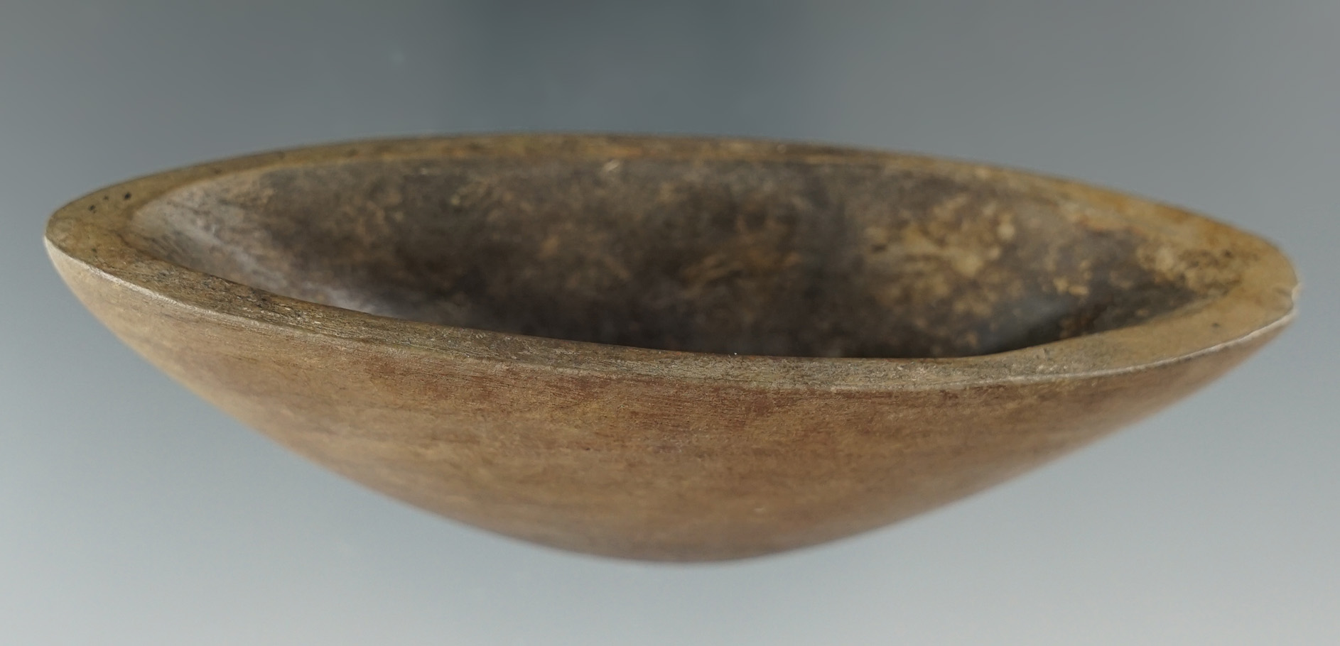 3 7/8" Deeply scooped Boatstone found in Oklahoma that is one half professionally restored.