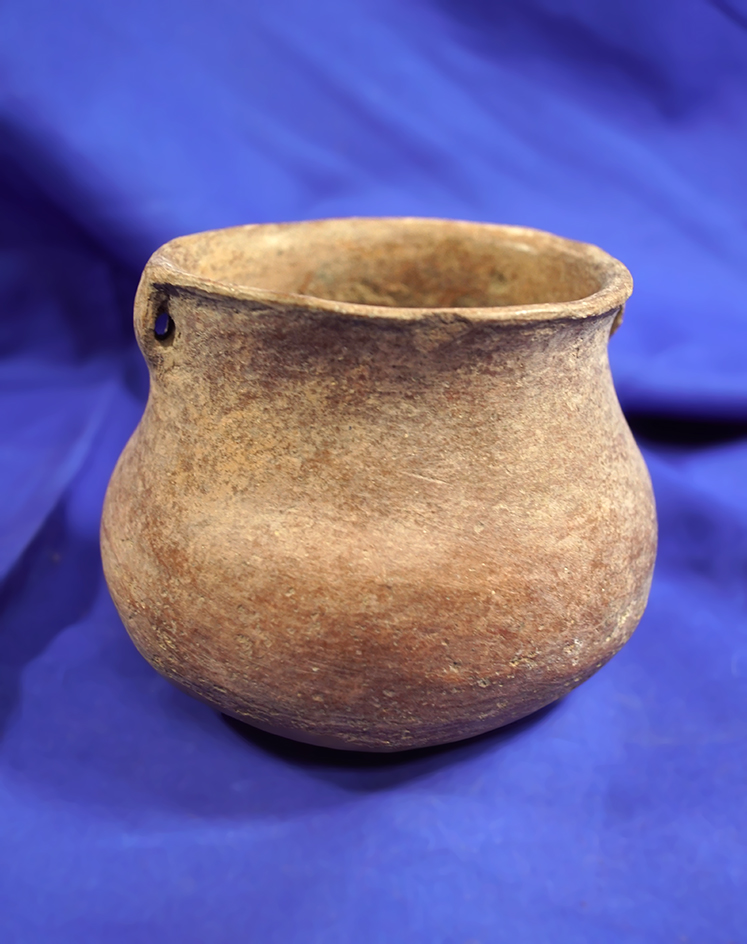 4 1/8" wide x 3 1/8" tall Pre-Columbian strap handle pottery vessel in good condition.