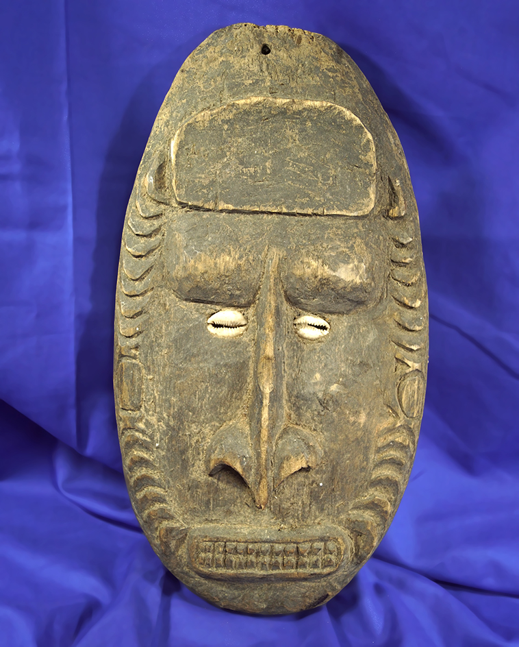 13" tall African wood carved facial totem with Cowry shell eyes.