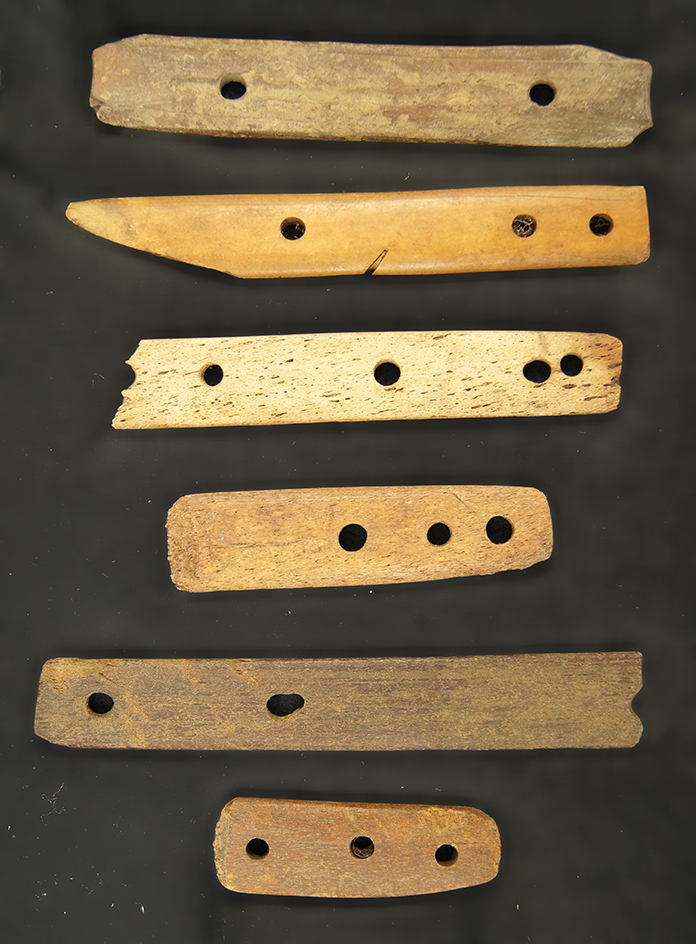 Frame of 6 pcs. of Eskimo bone found in Alaska. Ex. Neil Ecklund Collection. Largest is 6 1/2".