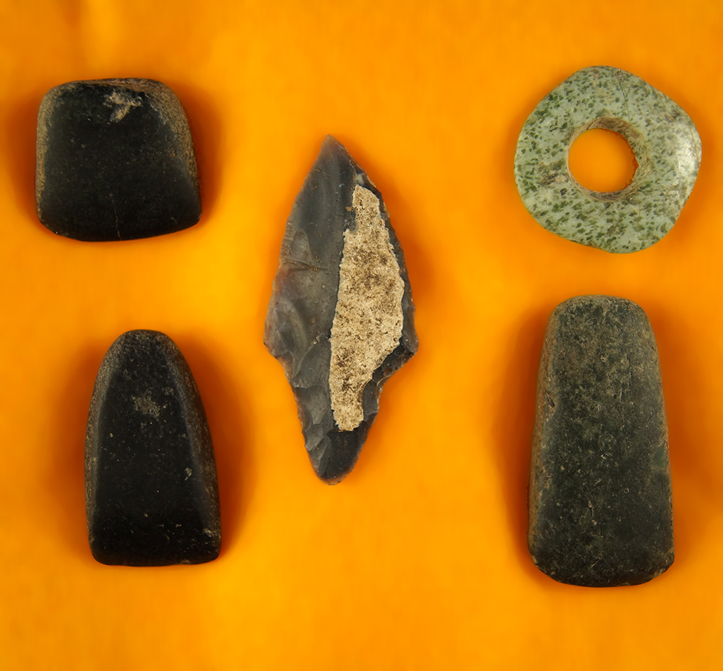 Frame with three miniature Mayan Celts, a point and Jade Earflare. Largest is 1 7/8".