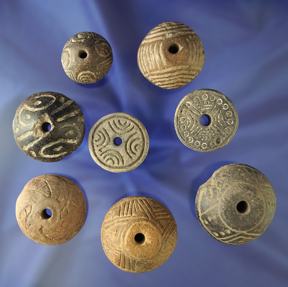 Set of seven nicely decorated spindle whorls found in Mexico. Largest is 1 9/16" diameter.