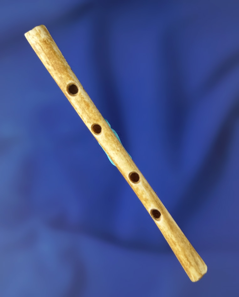 3 3/8" four hole bone flute found in Kentucky in good condition.
