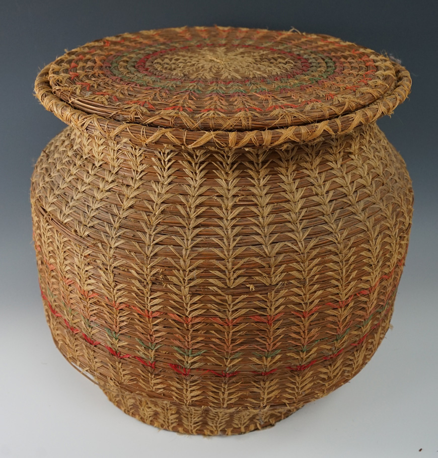Large 12" Tall x 13" wide woven pine needle basket in good condition with original lid.