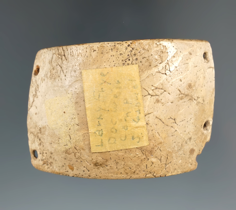 2 9/16" Shell Wrist Band with four perforations in the corners found  at the "Doc Weir camp"