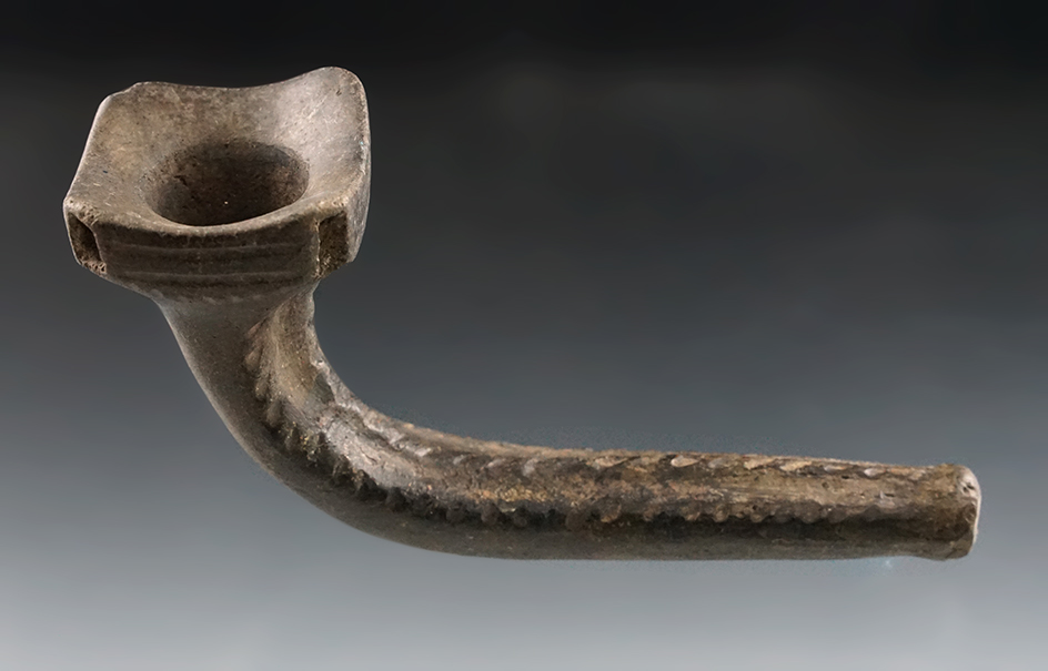 4 3/4" Nicely decorated Huronian Clay Pipe with a squared bowl and castellations. .