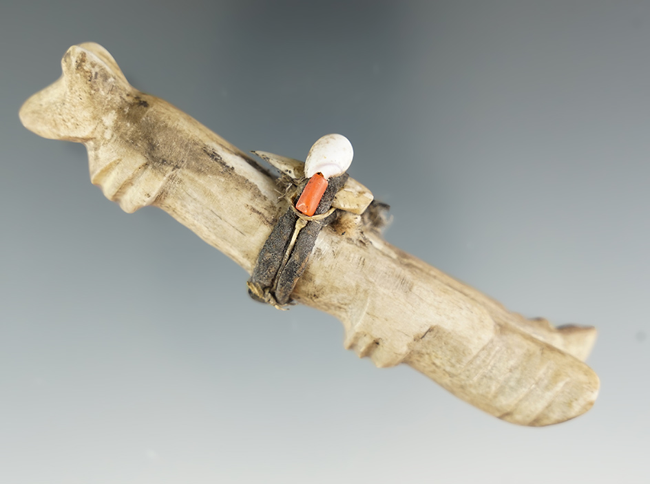 Old and uniquely carved 4"  Zuni animal fetish with original leather, shell and trade bead wrap.