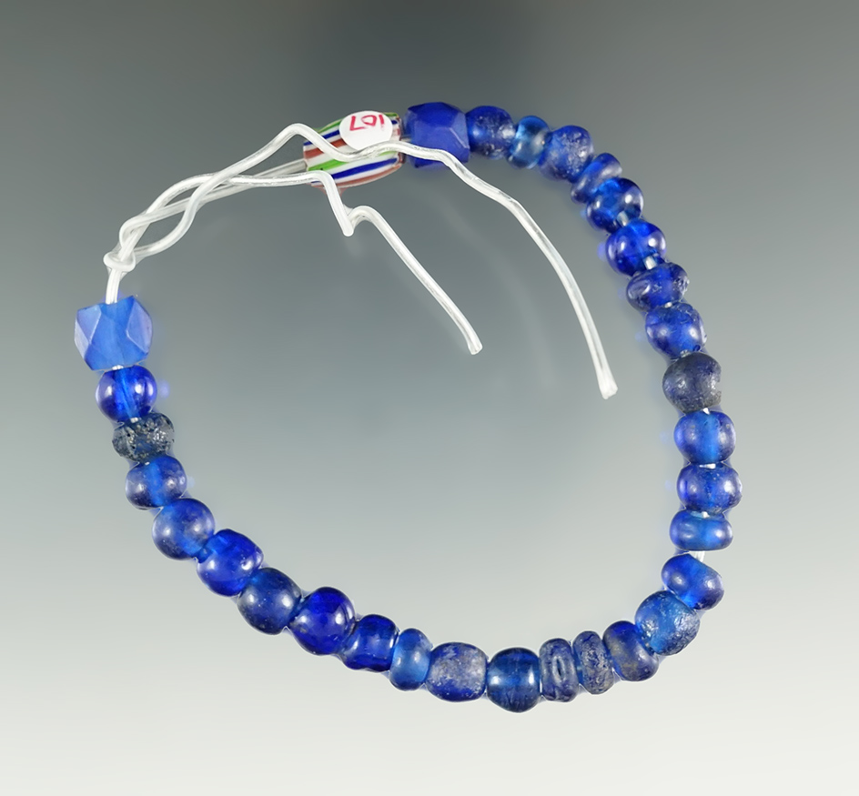 7" strand of 31 trade beads including 28 Blue Russians, and 3 others. Columbia River.