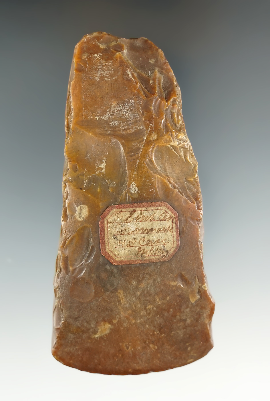 Heavily patinated and nicely styled 3 3/4" Danish Flint Celt with nice old collector tag. Denmark.