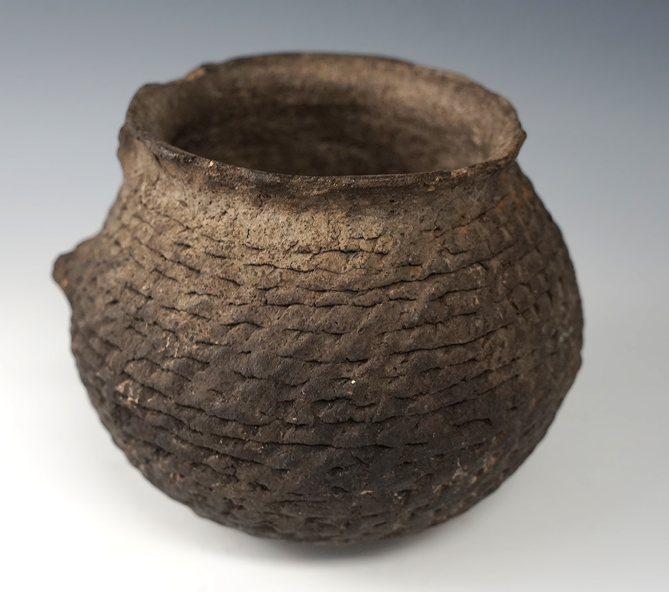 5 1/4" wide corrugated Southwestern bowl. Strap handle is missing and a couple rim chips