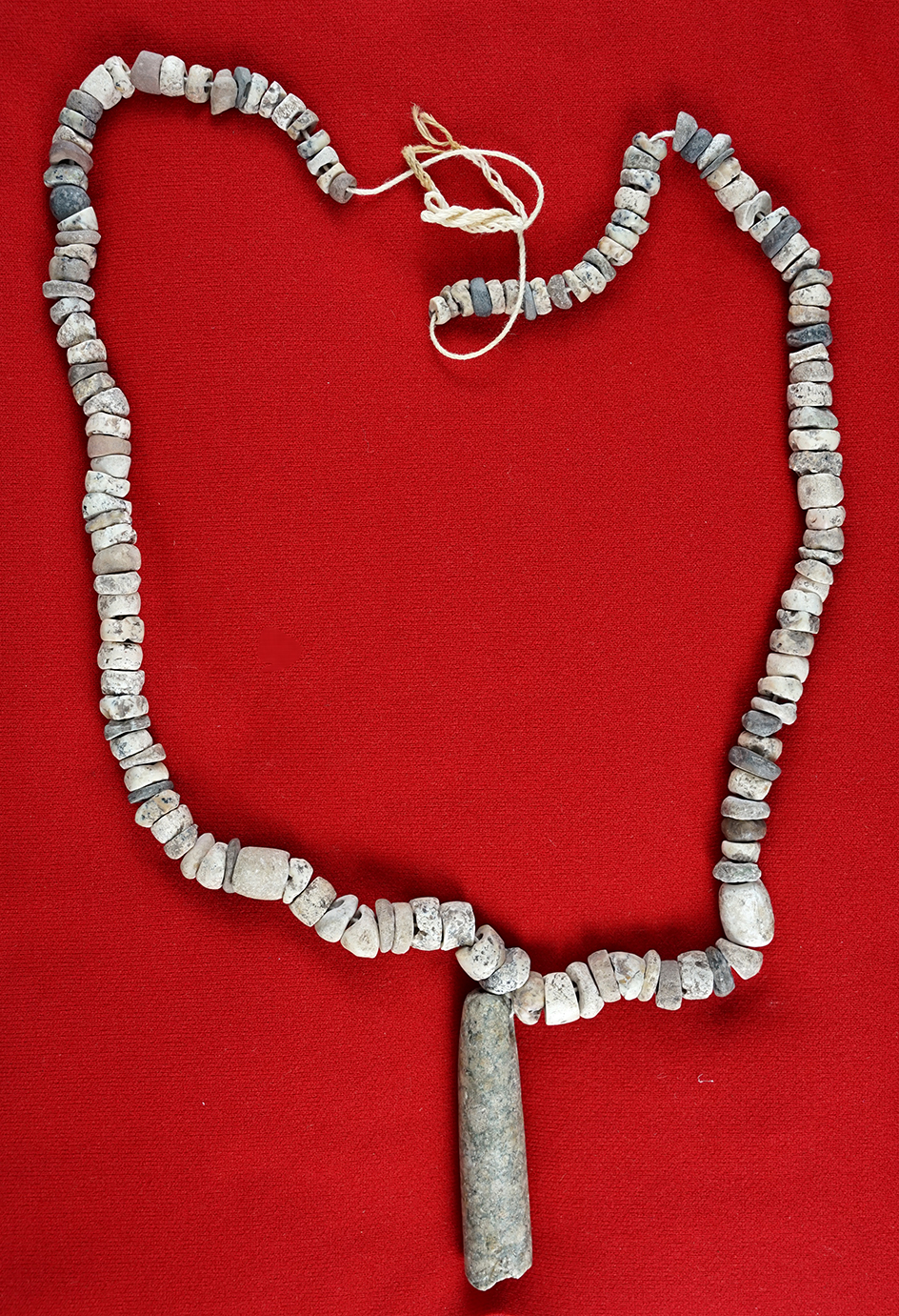 23" Long strand of drilled Stone Beads with a 2 1/4" stone pendant/tube bead.  Brown Co., Texas.