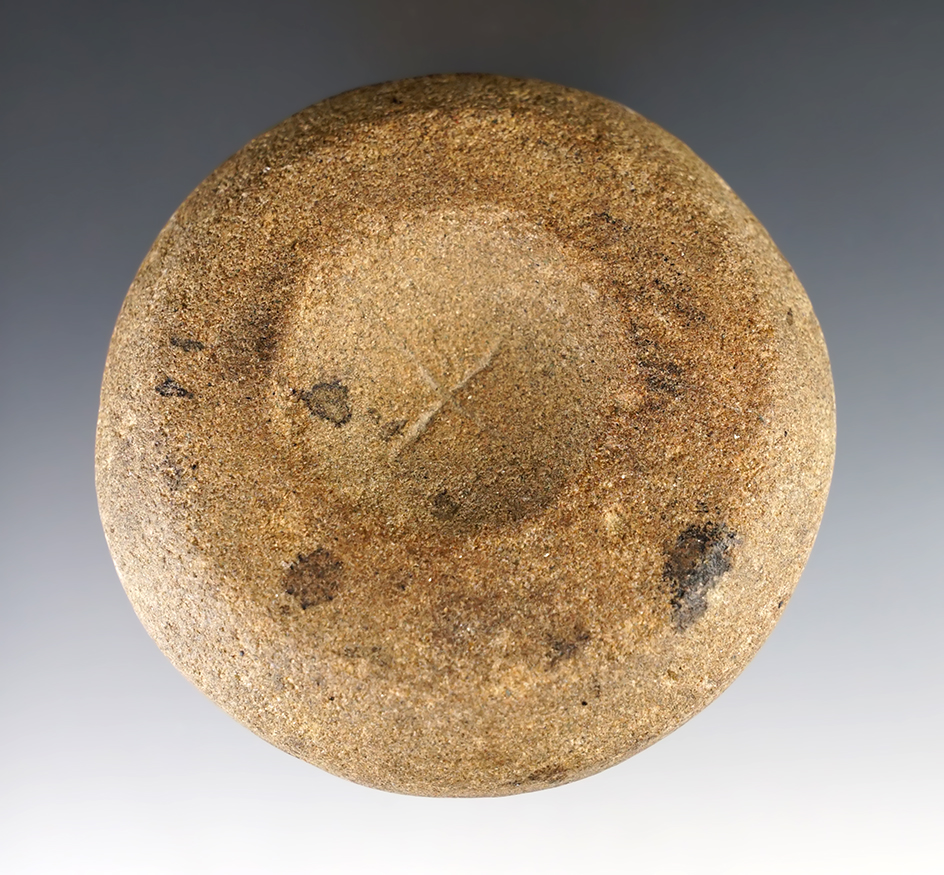 3 1/2" wide Discoidal -cupped on both faces. One side has an "X" pattern engraved on it. 