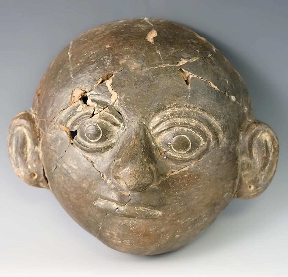 7 3/8" tall pre-Columbian pottery face with multiple reglued pieces which can be restored.