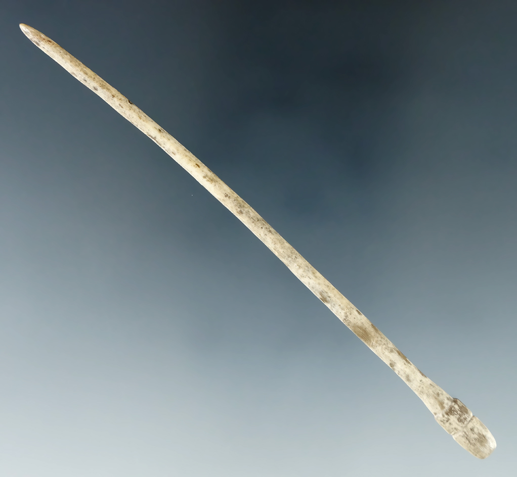 Delicately made 4 1/8" polished bone with an incised carved end. Found in Tennessee.