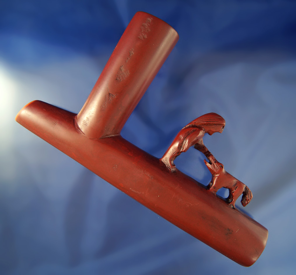 Large and very well carved 7 1/2" long Catlinite pipe with an effigy carving of a man and his dog.