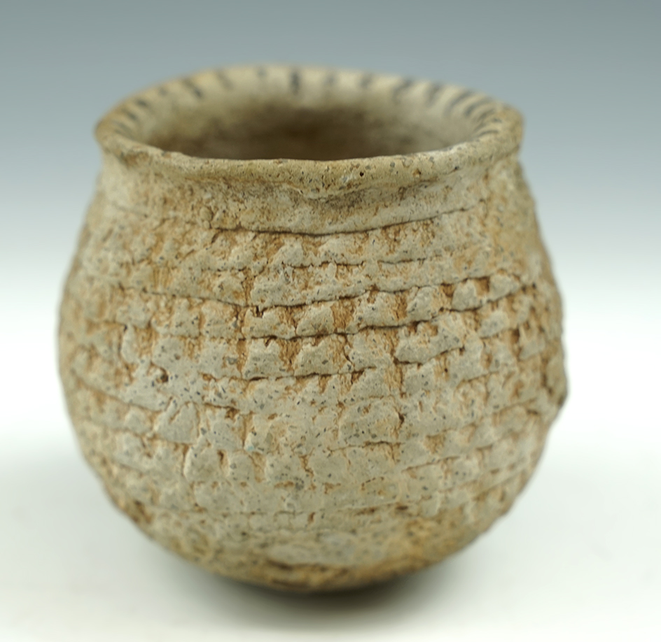 2 3/4" tall miniature Pueblo pottery jar with nice paint around rim found in New Mexico.