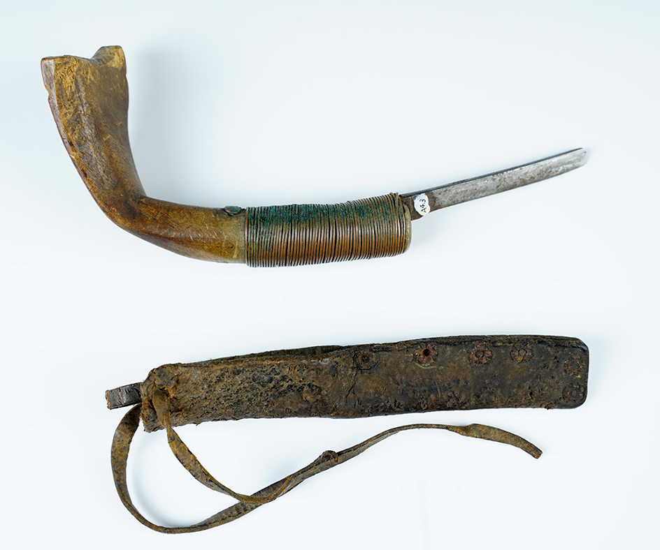 8"  curved knife with a wood handle, steel blade and copper wrap. Original leather case.