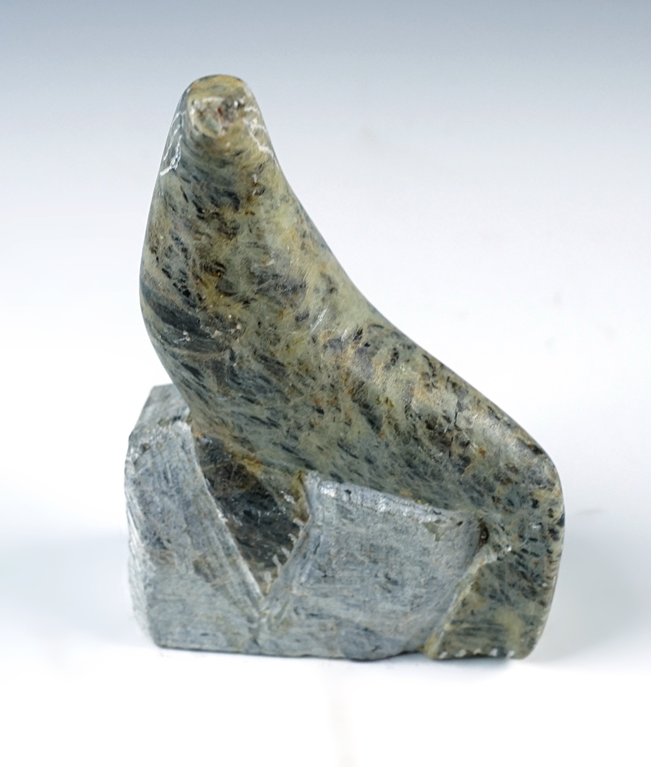 4" tall x 2 3/4" wide hand carved stone seal effigy from Alaska. Artist signature on base.