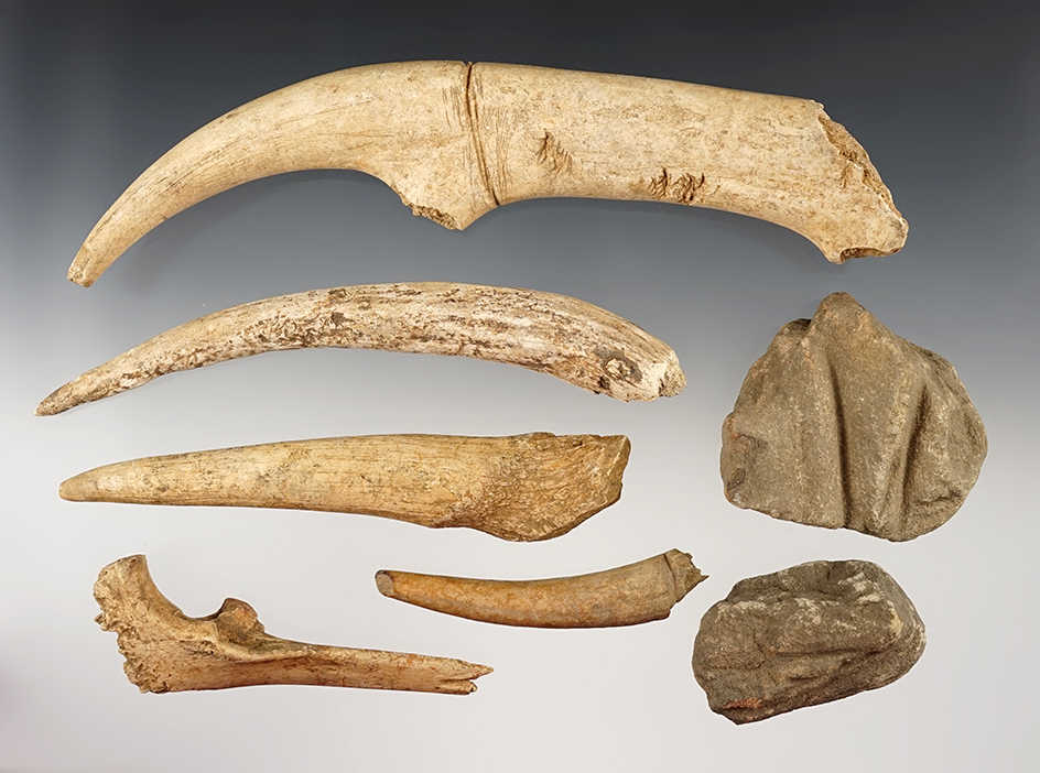 Set of 7 Bone Tools and Sandstone Abrading Stones. The largest is 7 1/4".