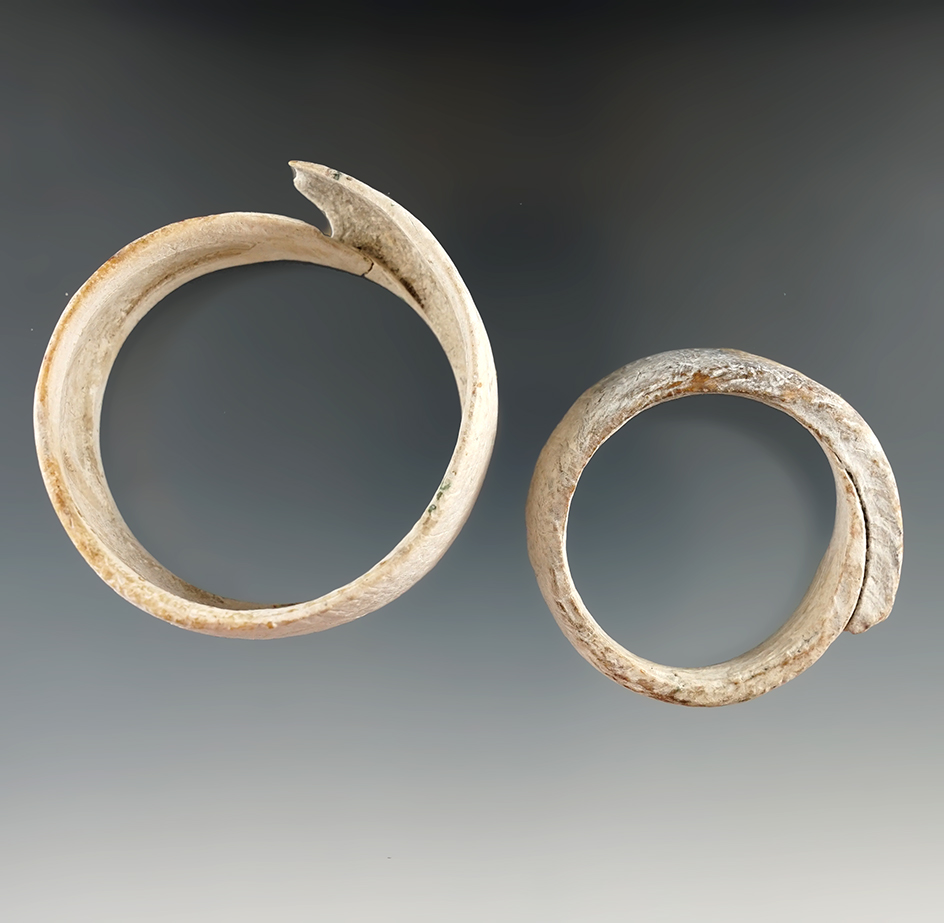 Nice pair of Marine shell ornaments that are beautifully styled found in Arizona. Largest is 2 1/2".