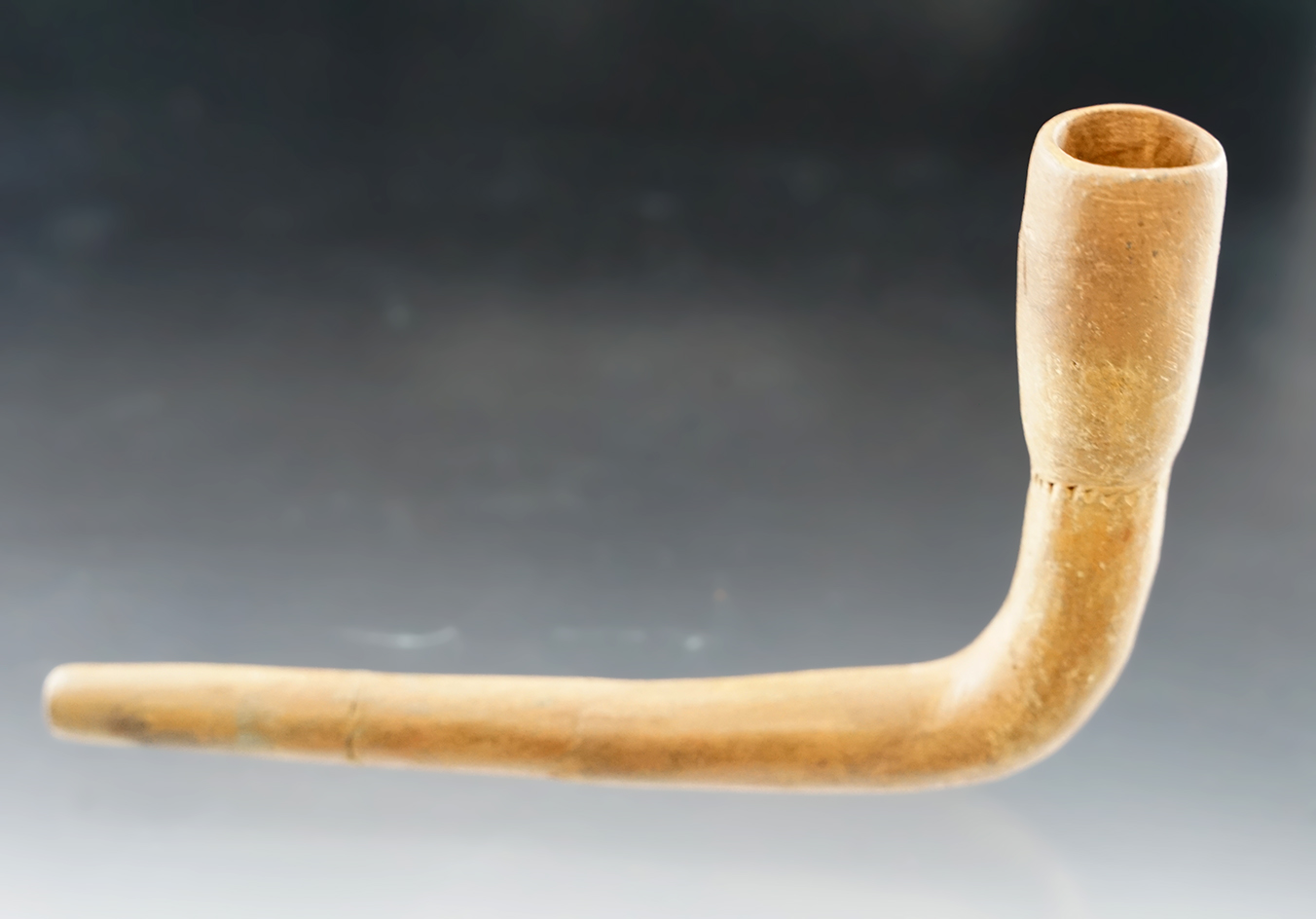 4 1/2" Long Iroquois clay tulip bowl pipe with restoration to the upper bowl and stem. New York.