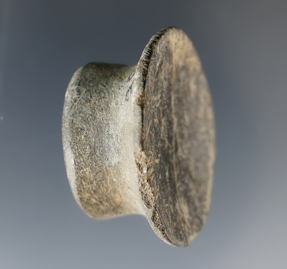1 3/4" nicely styled ear ornament found in Sutter Co., California.Heavily patinated stone.