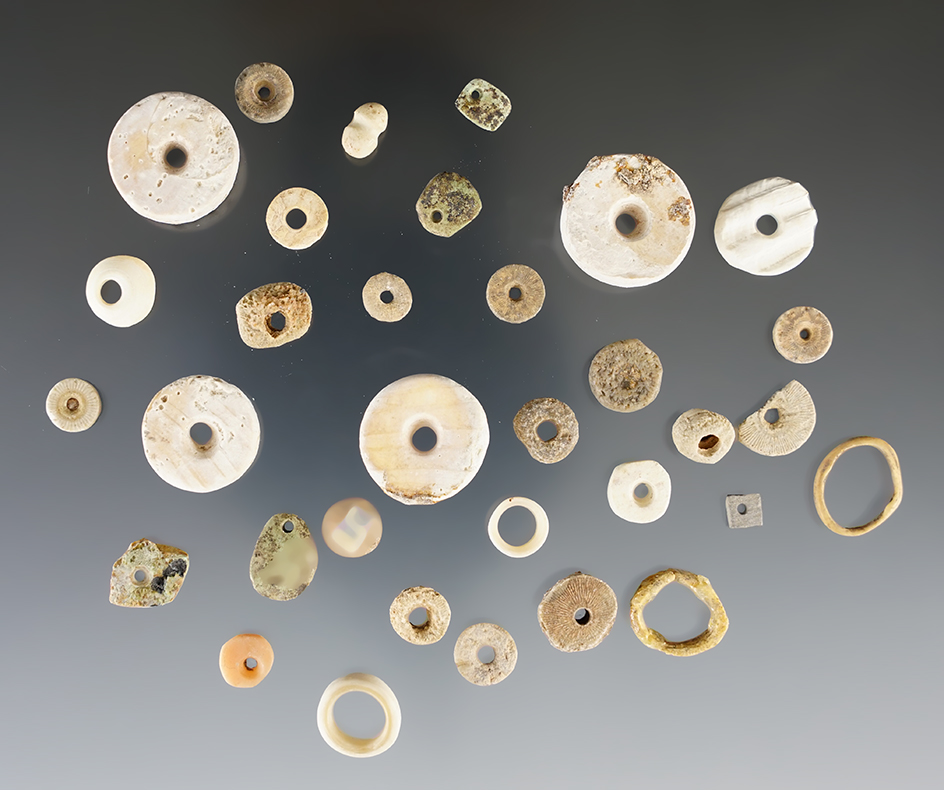 Nice assortment of drilled stone and shell beads found in New Mexico. Largest is 11/16".