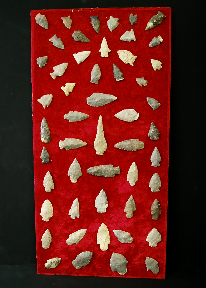 Old display board with many glued on arrowheads and knives from Tennessee. Largest is 3 1/2".