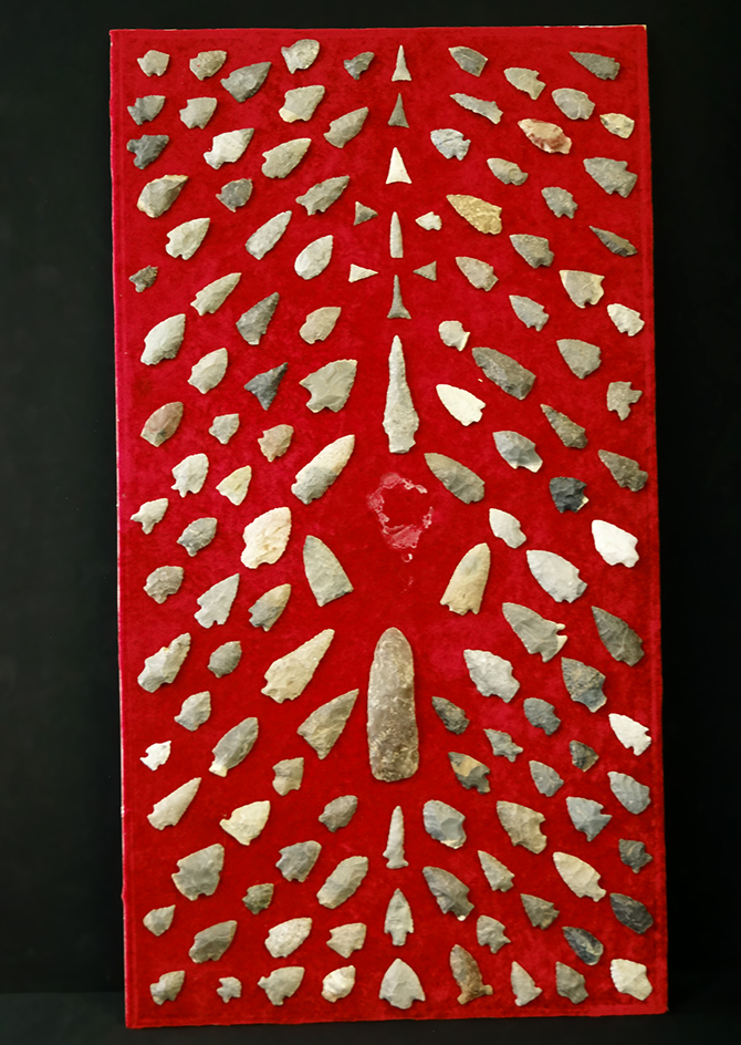 Old display board with many glued on arrowheads and knives from Tennessee. Largest is 4 3/4".
