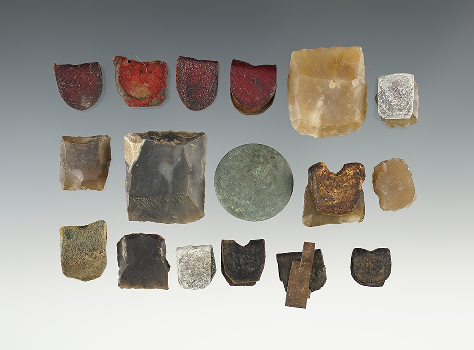 Group of fur trade era Gun flints and Gunflint holders. Holders are made from leather and lead.