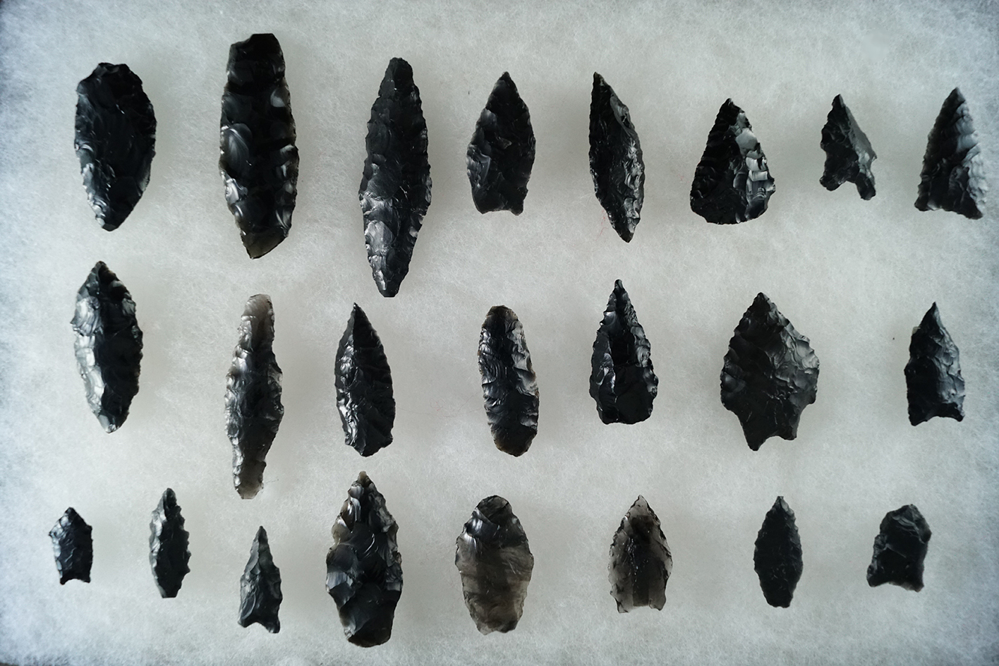 Set of 23 obsidian flaked artifacts from the Great Basin area, largest is 2 5/8".