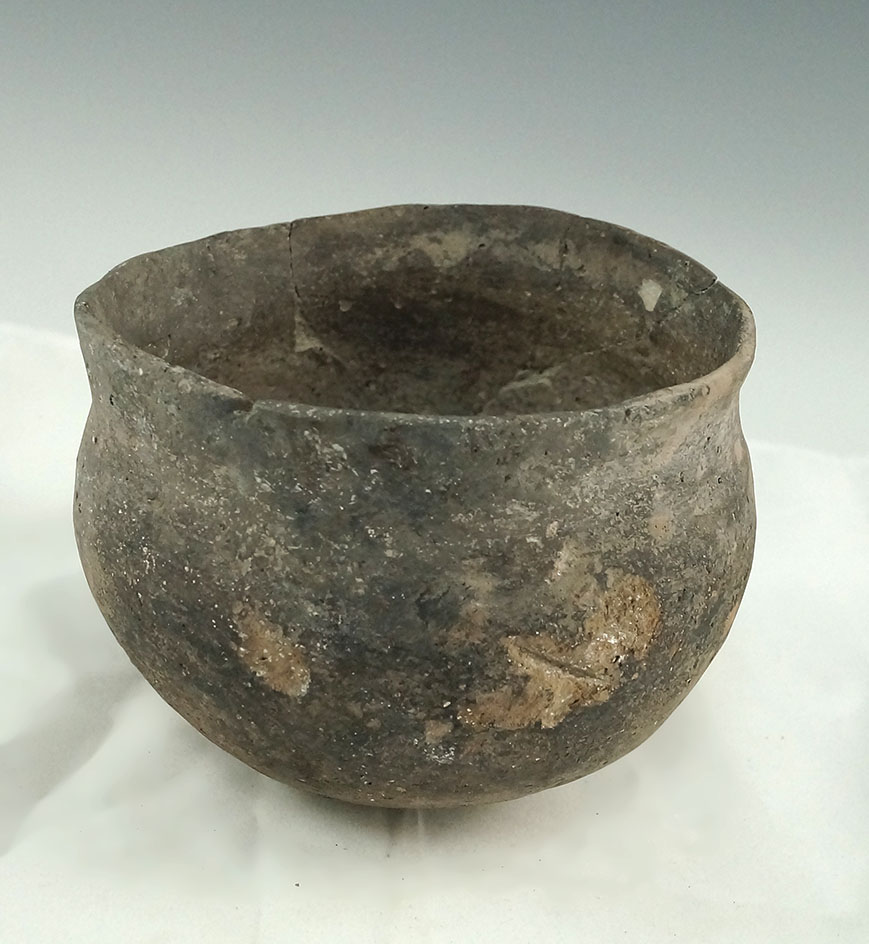 5" shell tempered clay Mississippian Jar with restoration to the rim area.