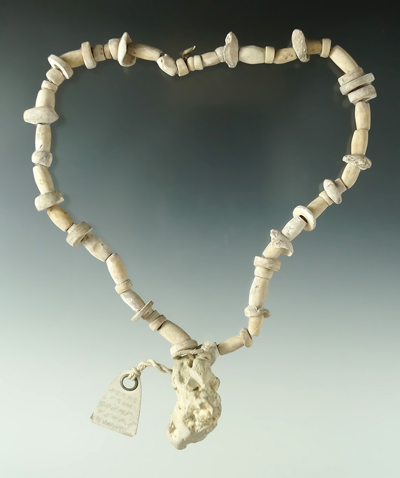 Unique 14" long strand of drilled bone, shell and stone beads with a naturally shape concretion.