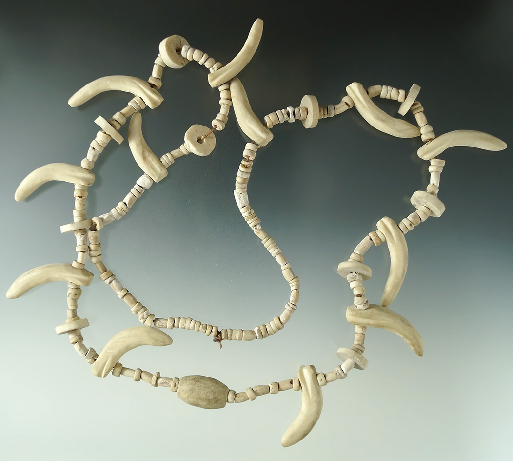 32" long strand of drilled stone and Shell beads and carved claw effigy beads made from stone/bone.