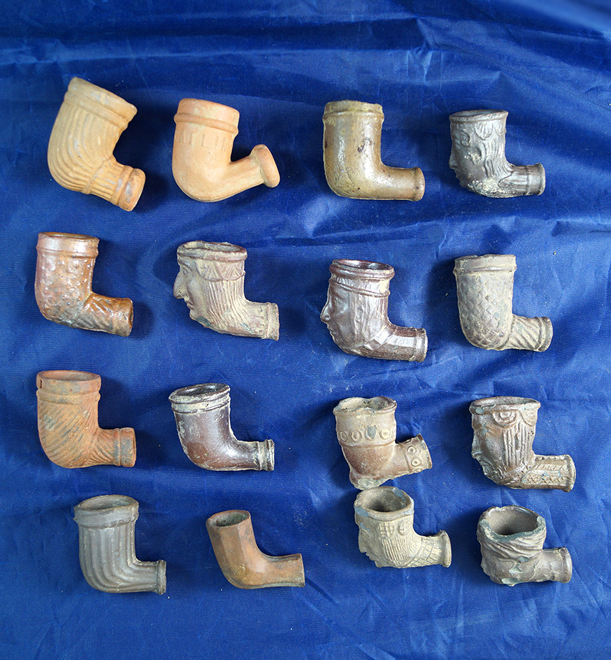 Large group of 16 Clay Pipes.  All are undamaged, a few are seconds.  Includes 6 "face" Pipes.